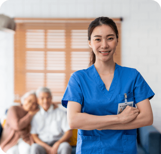 Nurse smiling with seniors in the background.
