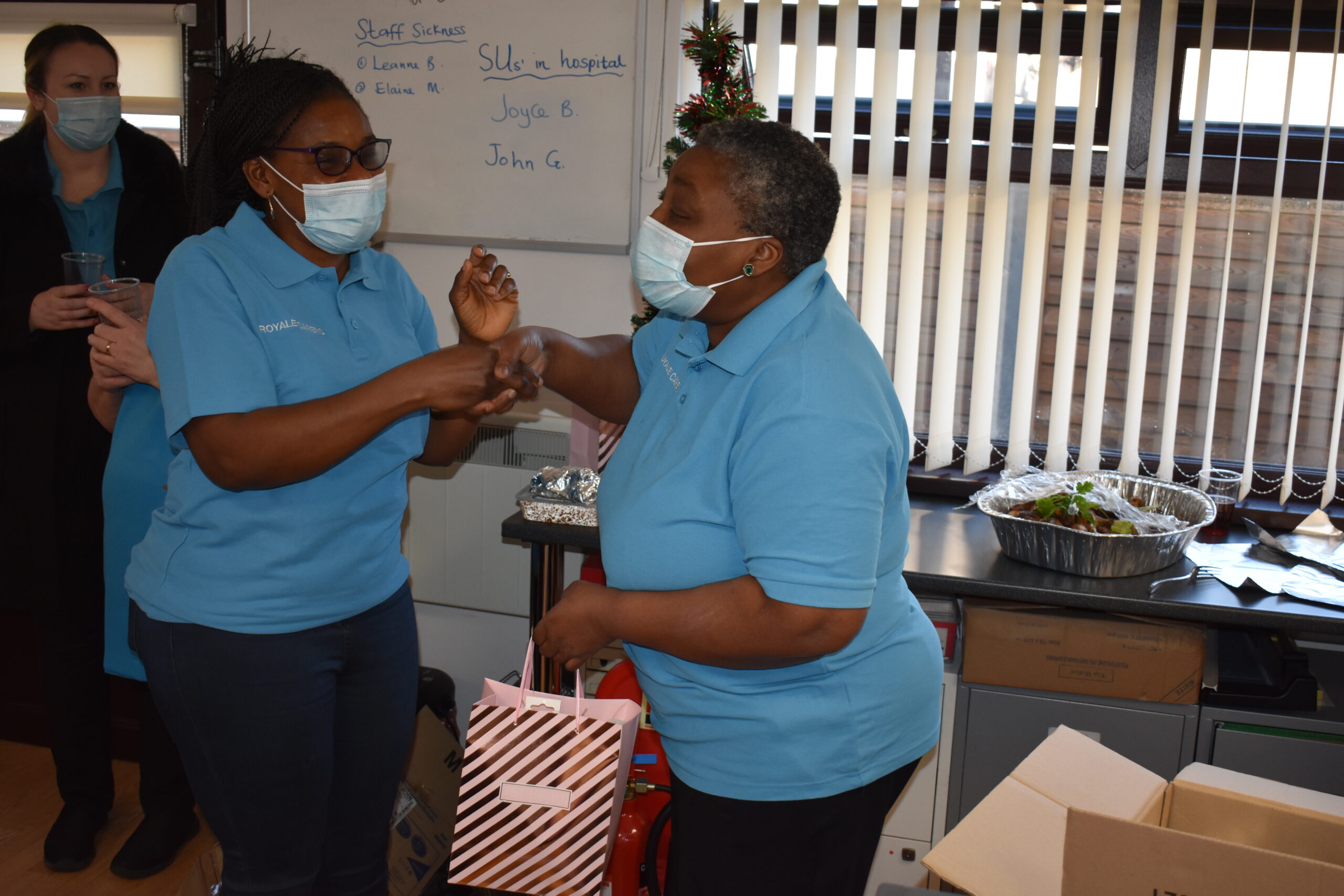 Staff members celebrating with gifts