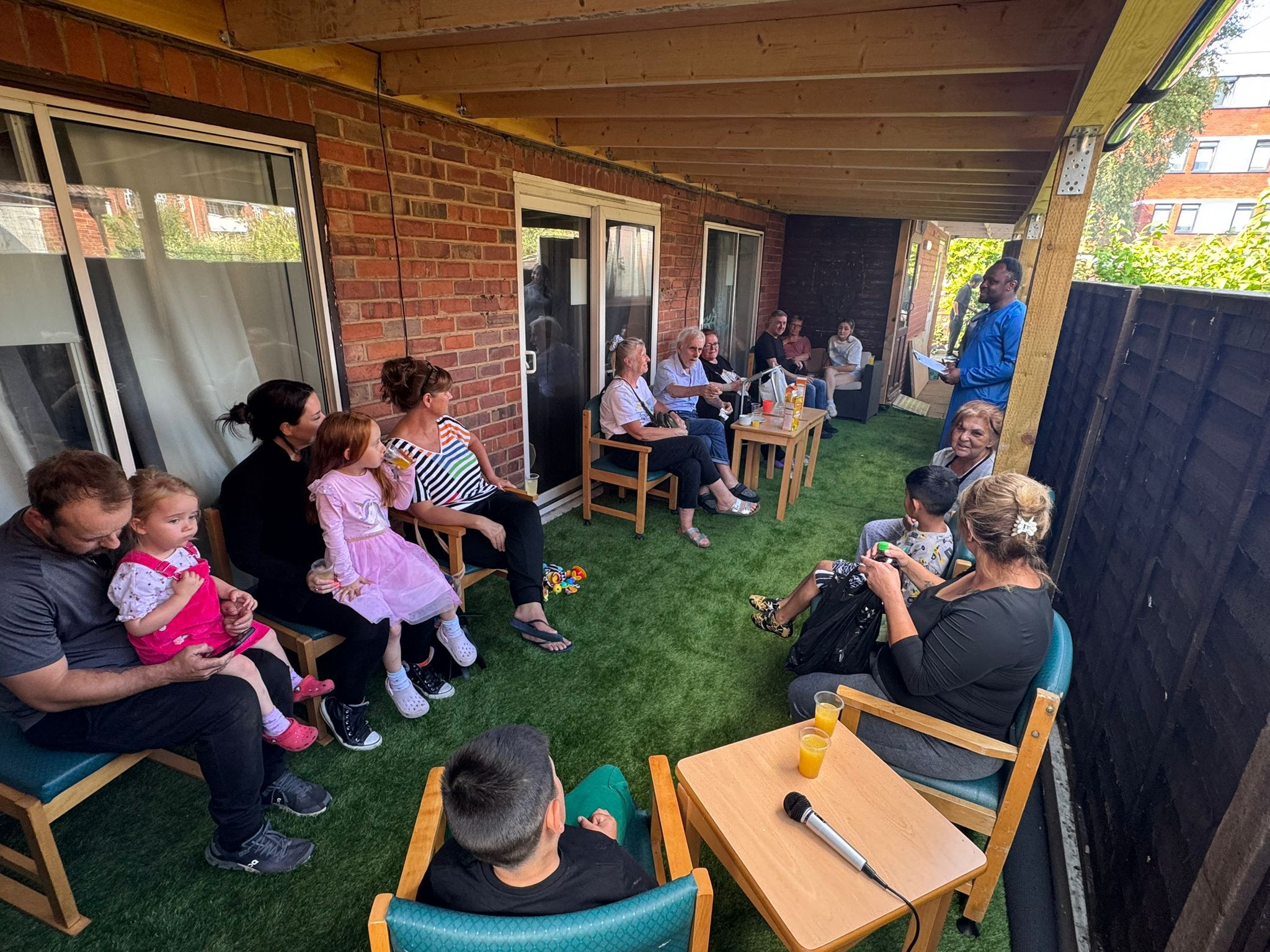 Residents and staff engaged in an outdoor gathering.