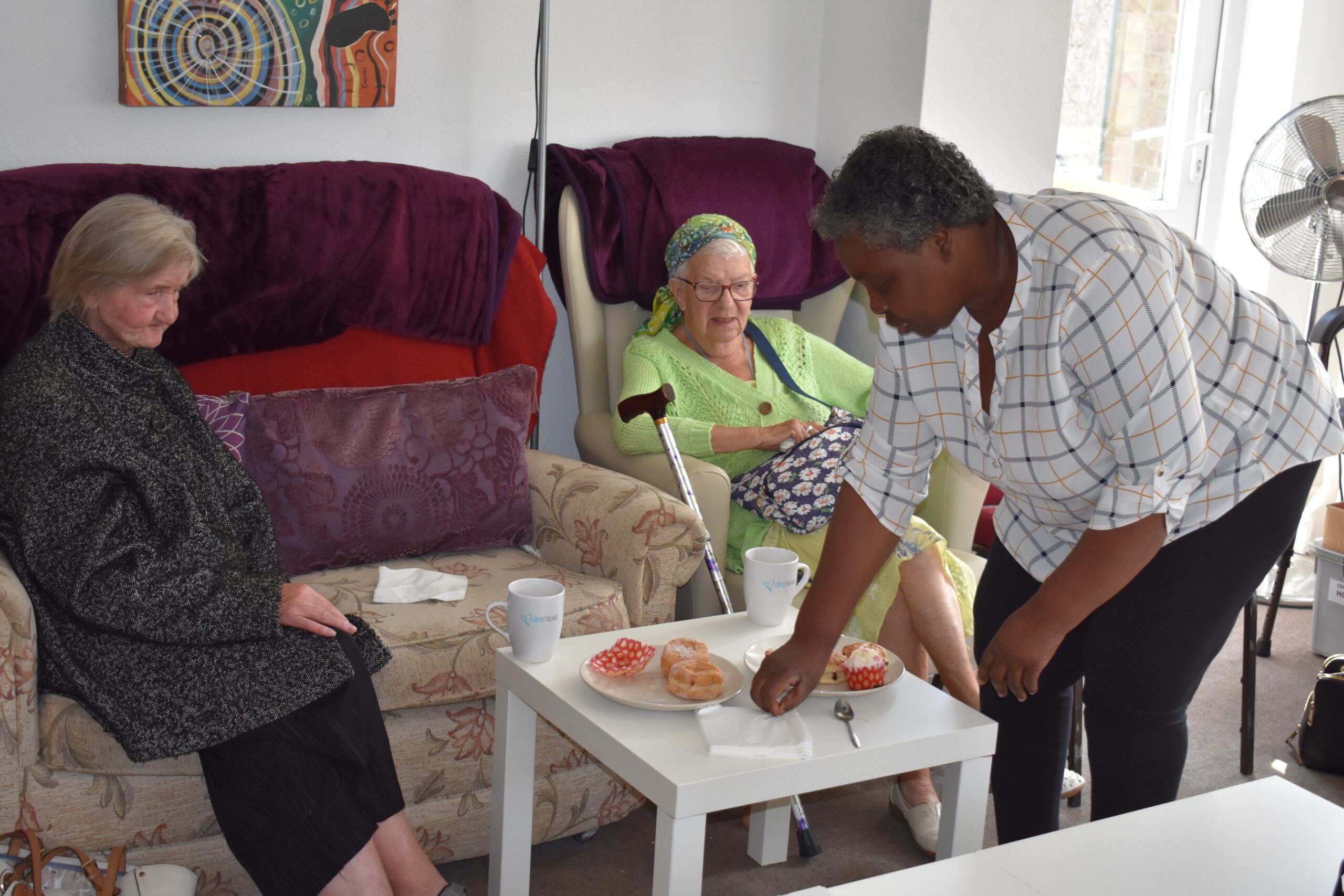 Residents enjoying snacks with a caregiver.