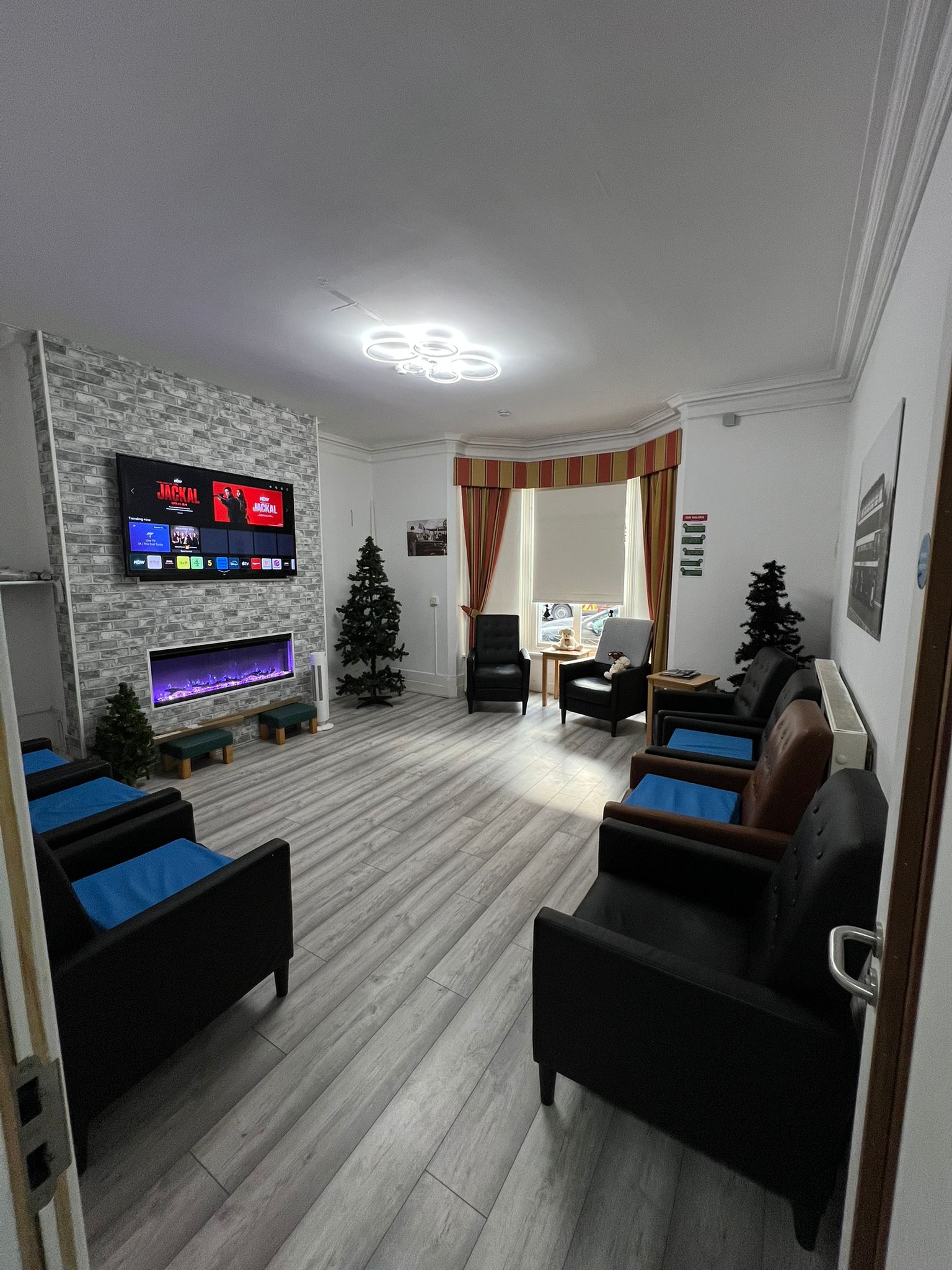 Interior lounge area with chairs and a TV
