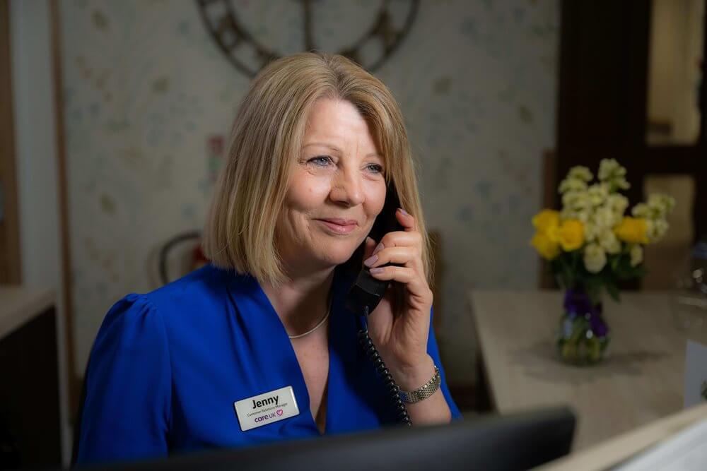 Receptionist talking on the phone at the facility