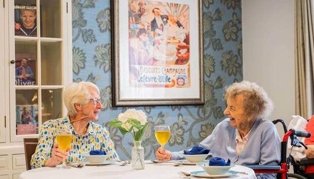 Two elderly women enjoying a meal together