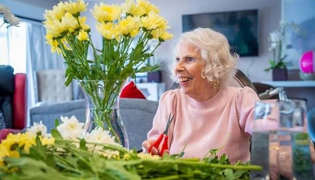 Resident enjoying flower arranging activity