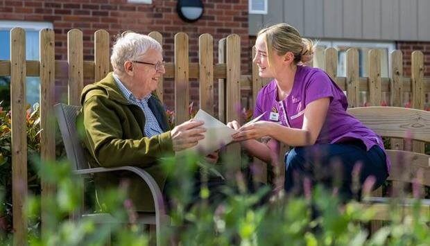 Caregiver interacting with a resident outdoors