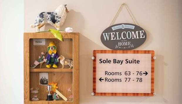Interior wall display with welcome sign and décor.