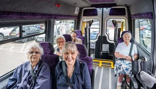 Senior residents enjoying a van ride together.