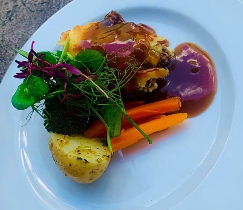 A plated meal with vegetables and sauce.