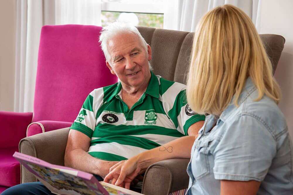 A resident engaged in conversation with staff