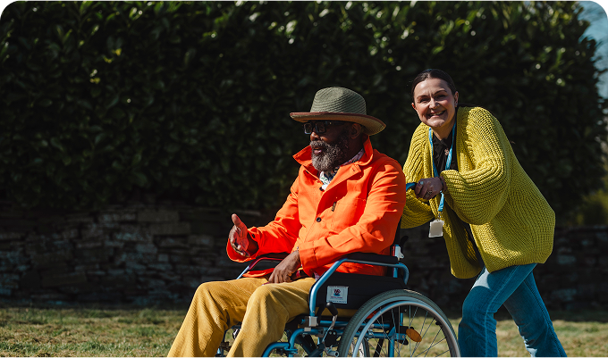 Resident and staff member enjoying outdoor time.