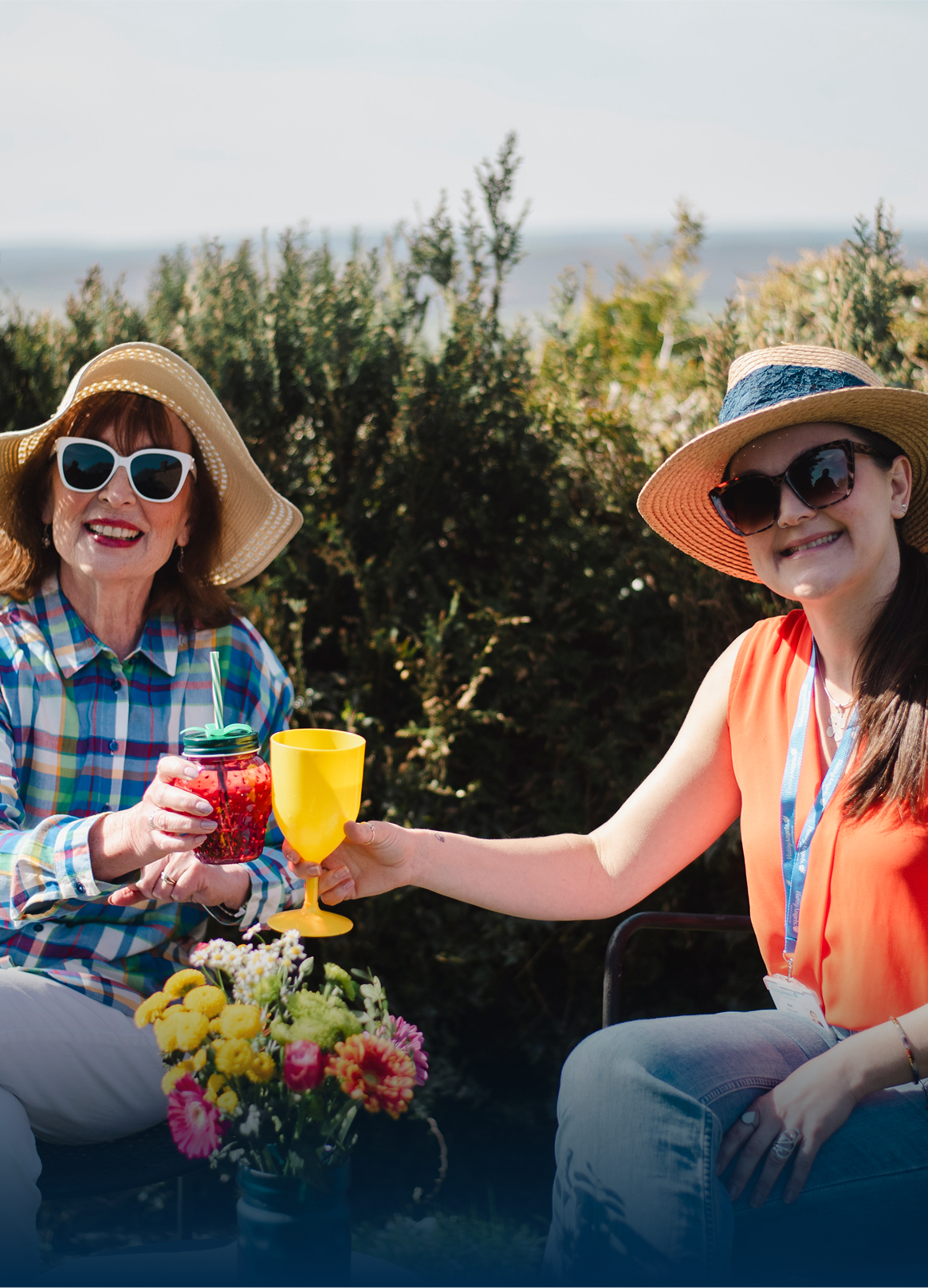 Residents enjoying drinks outdoors with staff