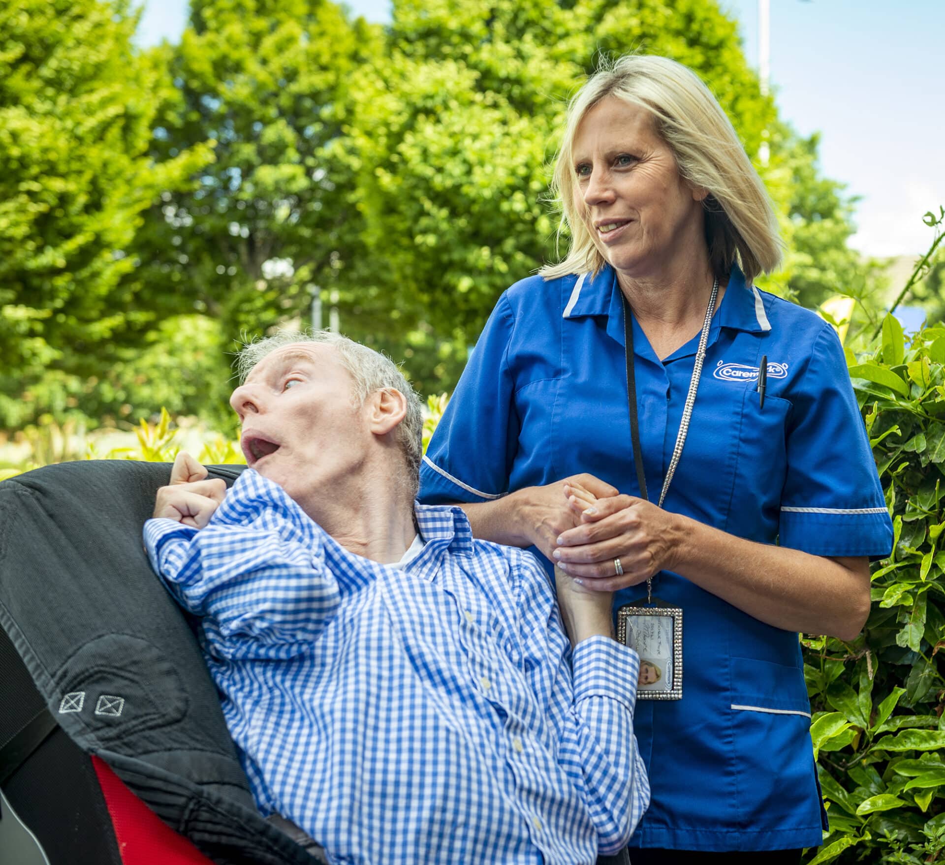 Staff assisting a resident outdoors