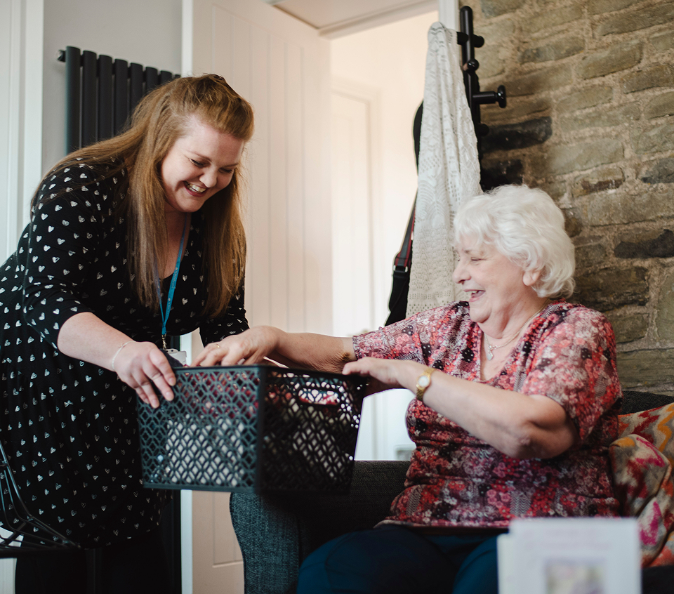 Staff member assisting a resident with a basket