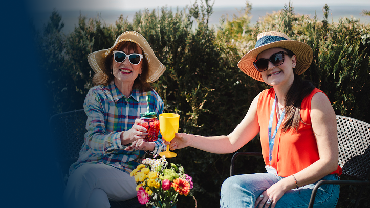 Two women enjoying drinks in an outdoor setting.