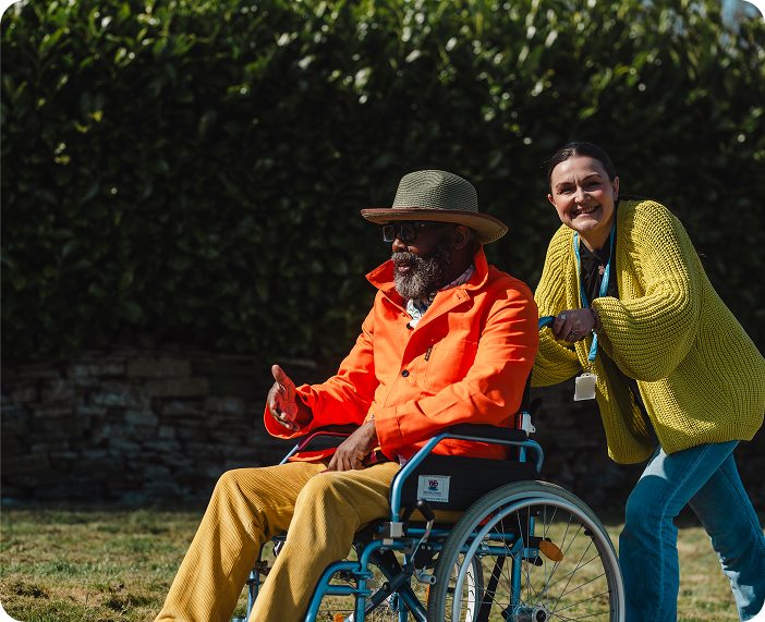 Resident enjoying time outside with staff member.