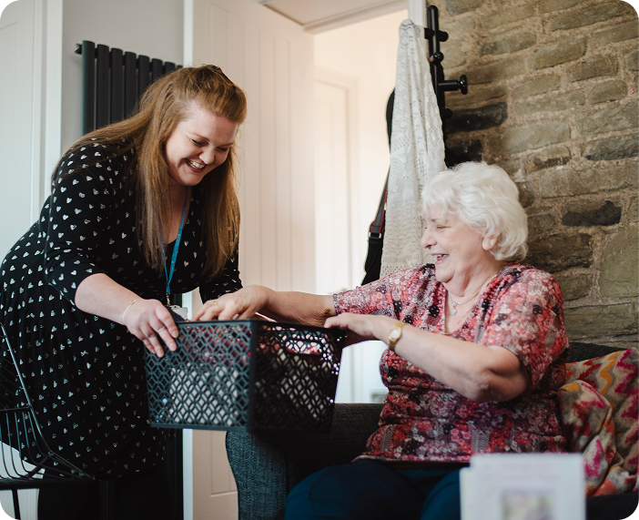 Caregiver assisting a resident with a basket