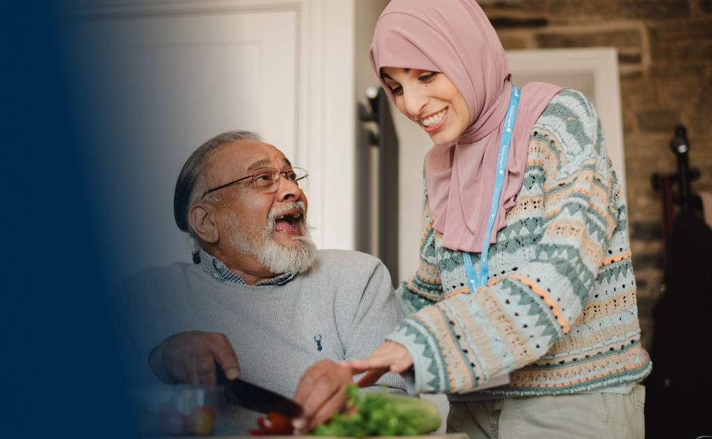 Caregiver helping a resident with food preparation.
