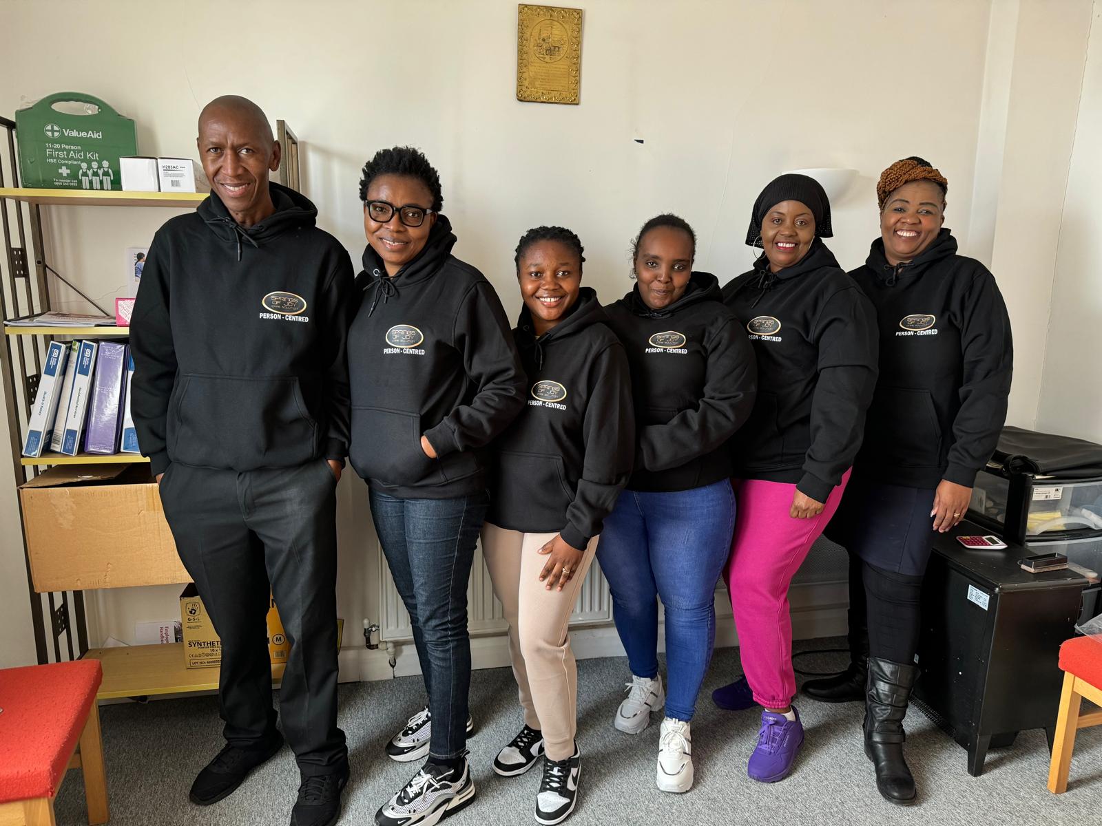Staff members in hoodies posing together