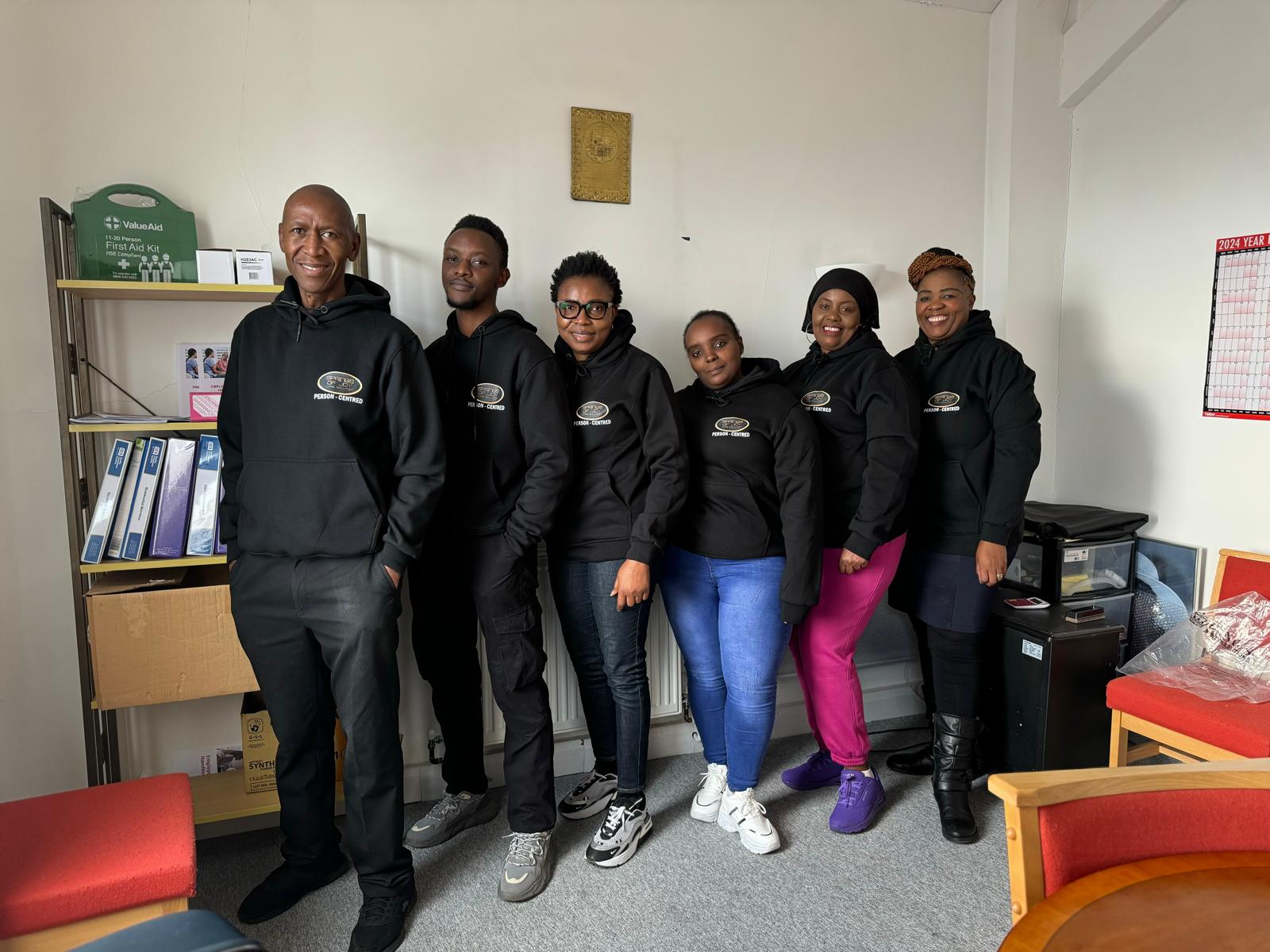 Staff posing together in a shared area