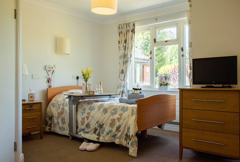 Cozy bedroom with floral bedding and natural light