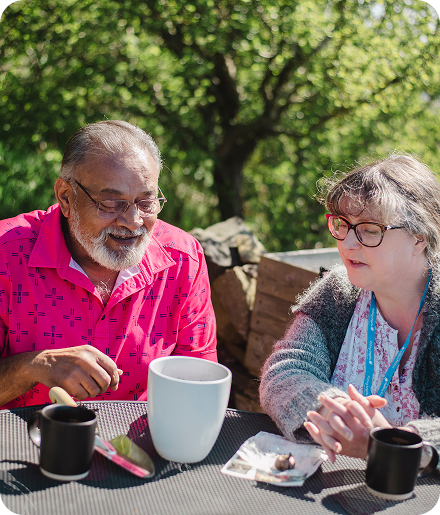 Two residents enjoying conversation outdoors