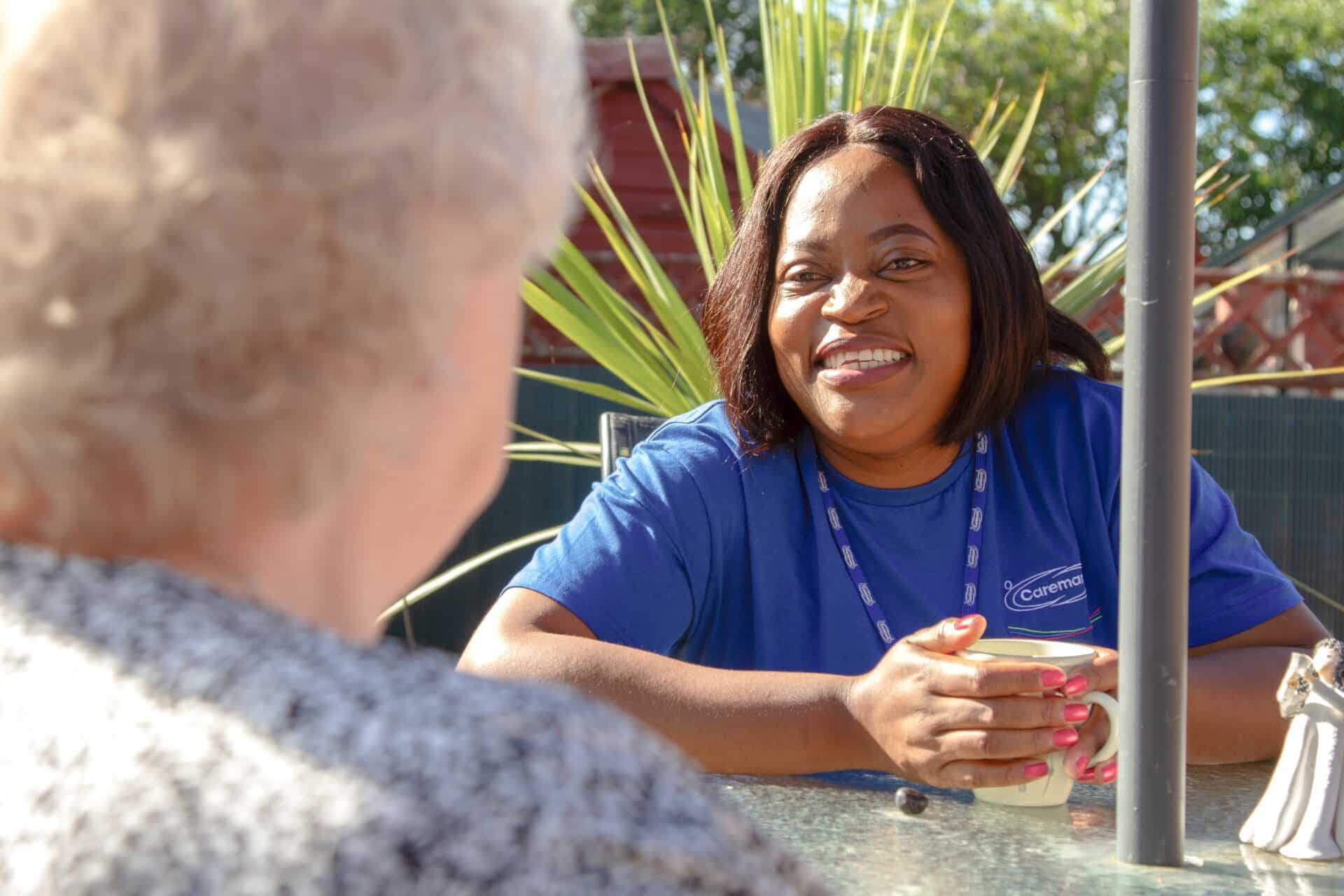 Staff member engaging with a resident outdoors.