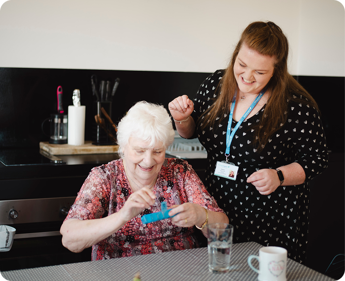 Resident and staff engaged in an activity.
