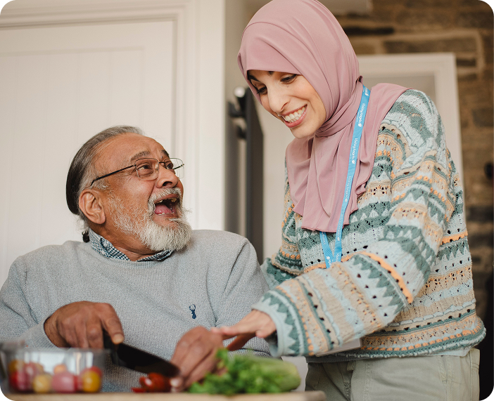 Caregiver and resident cooking together