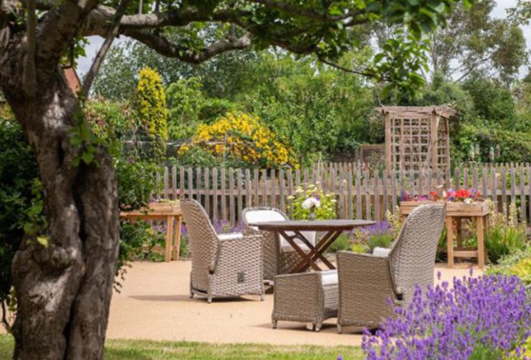 Outdoor seating area with garden flowers