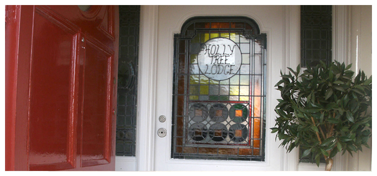 Entrance door with stained glass panel of Holly Tree Lodge
