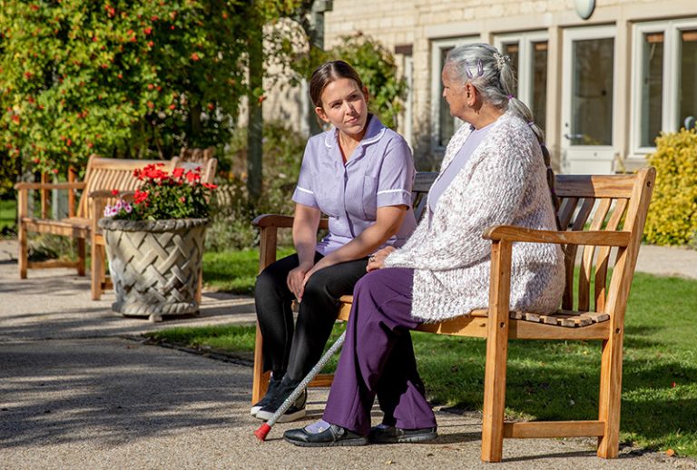 Staff member interacting with resident outdoors