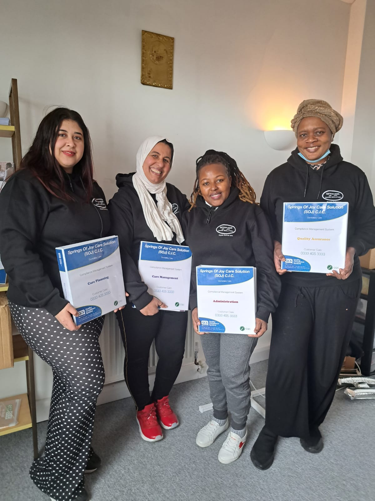 Staff members holding certification awards