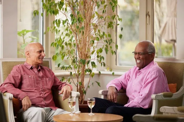 Two residents conversing in a common area