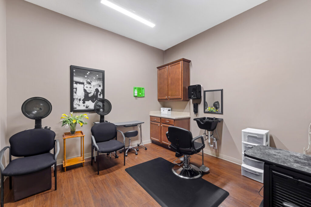 Hair salon area with styling chairs and equipment.