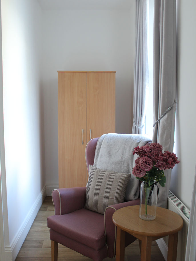 Cozy corner of a resident room with flowers.