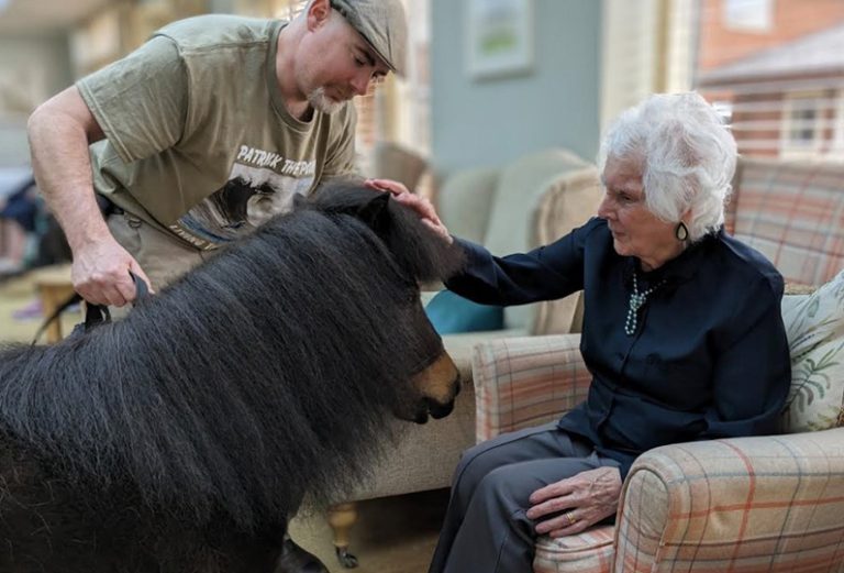 Resident interacting with a therapy dog.