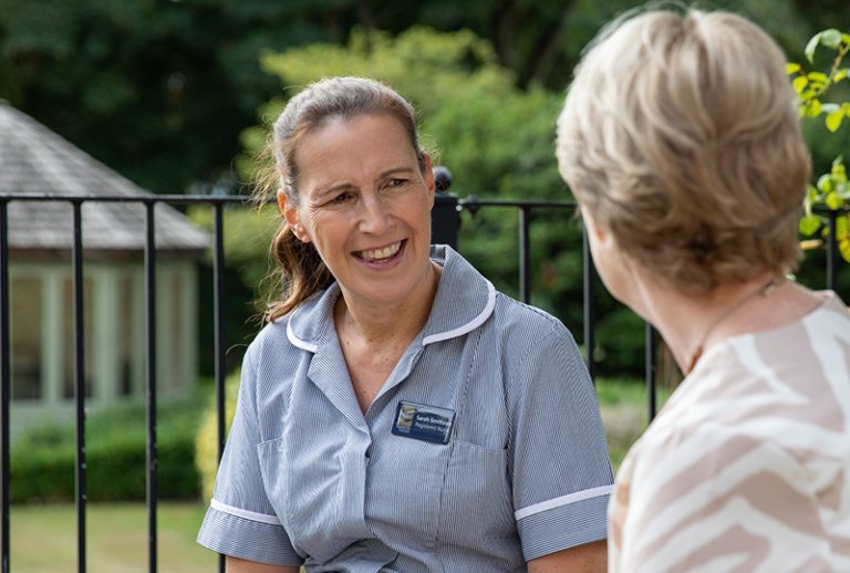 Staff member engaging with a resident outdoors