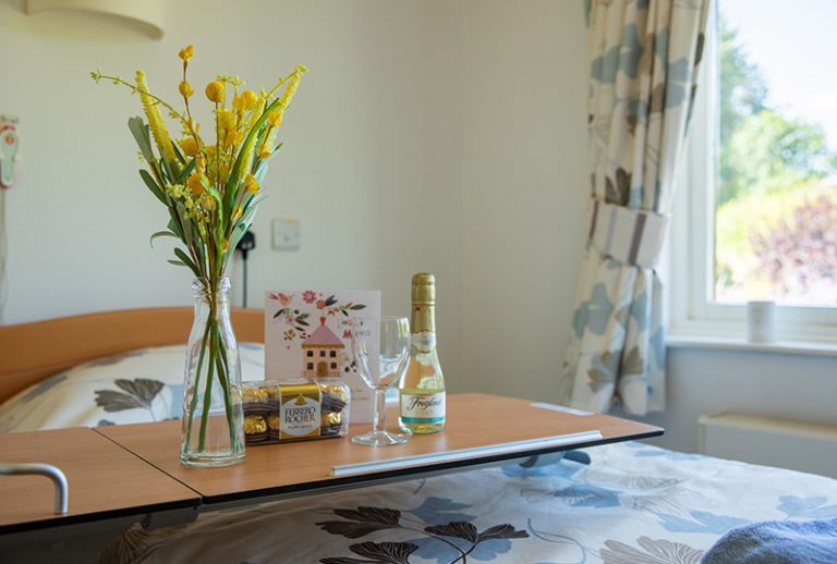 Cozy resident room with flowers and a drink