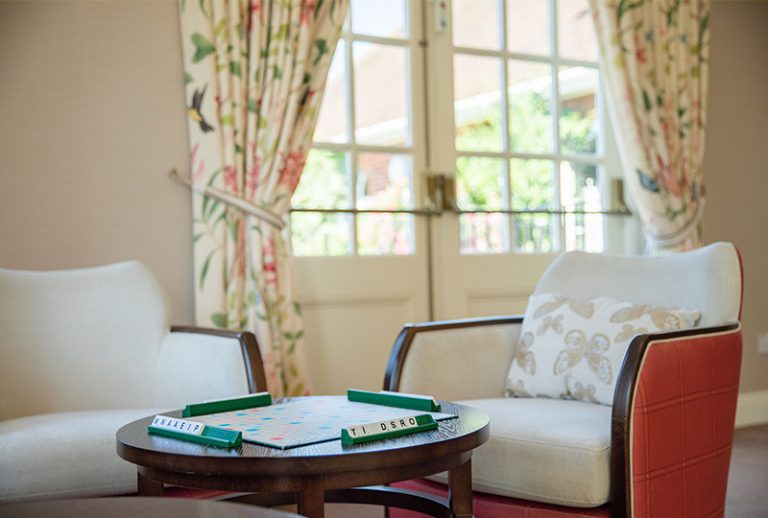 Cozy seating area with game table and floral curtains