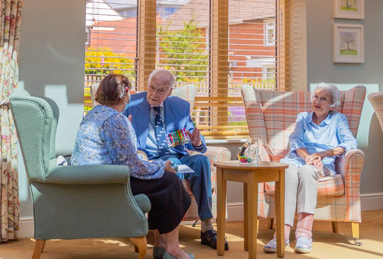Residents engaging in conversation in a common area.