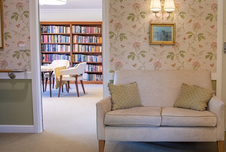 Cozy common area with bookshelves in the background.