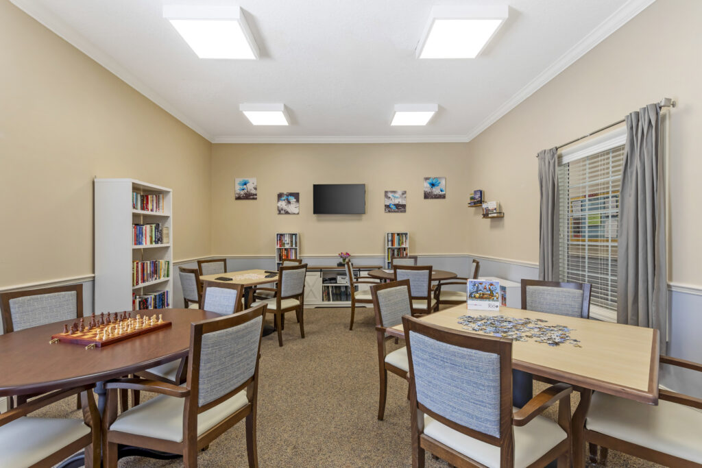Common area with tables and bookshelves.