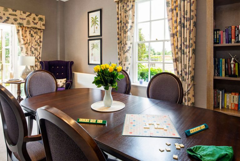 Common area with a large table and flowers