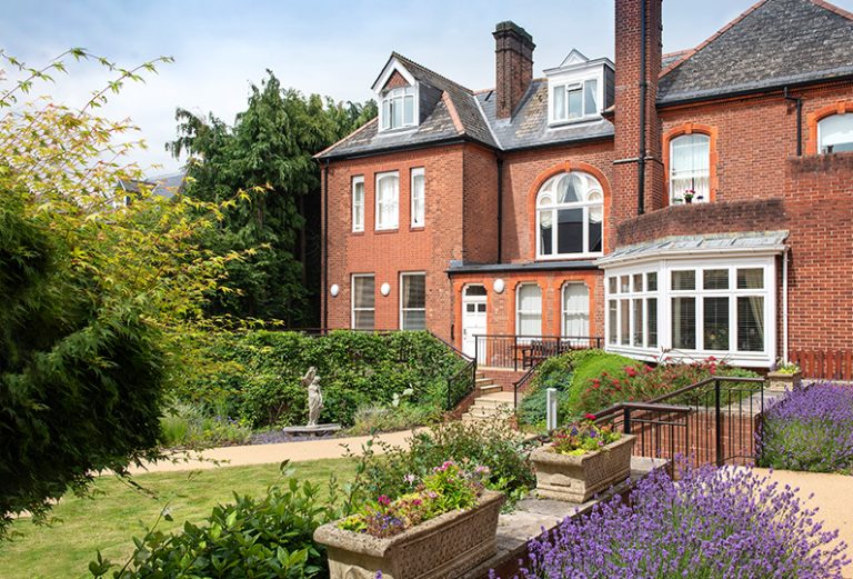 Exterior view of a care home with garden