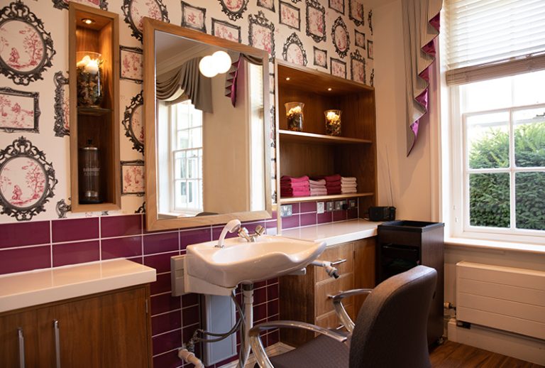Salon interior with a sink and mirror.