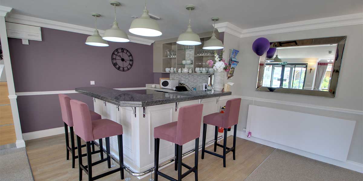 Modern common area with bar seating and decor.