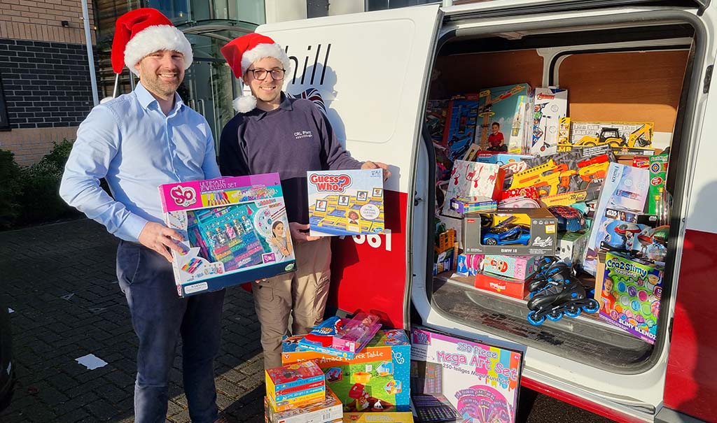Two staff members sharing holiday gifts