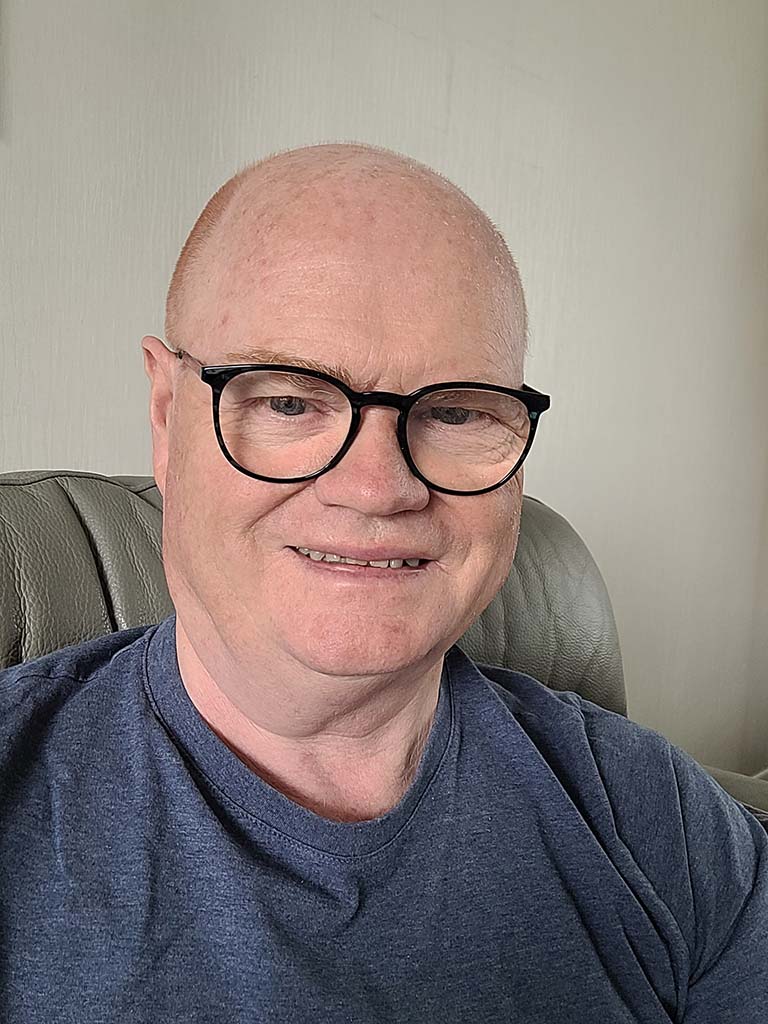 Older man smiling in a casual setting