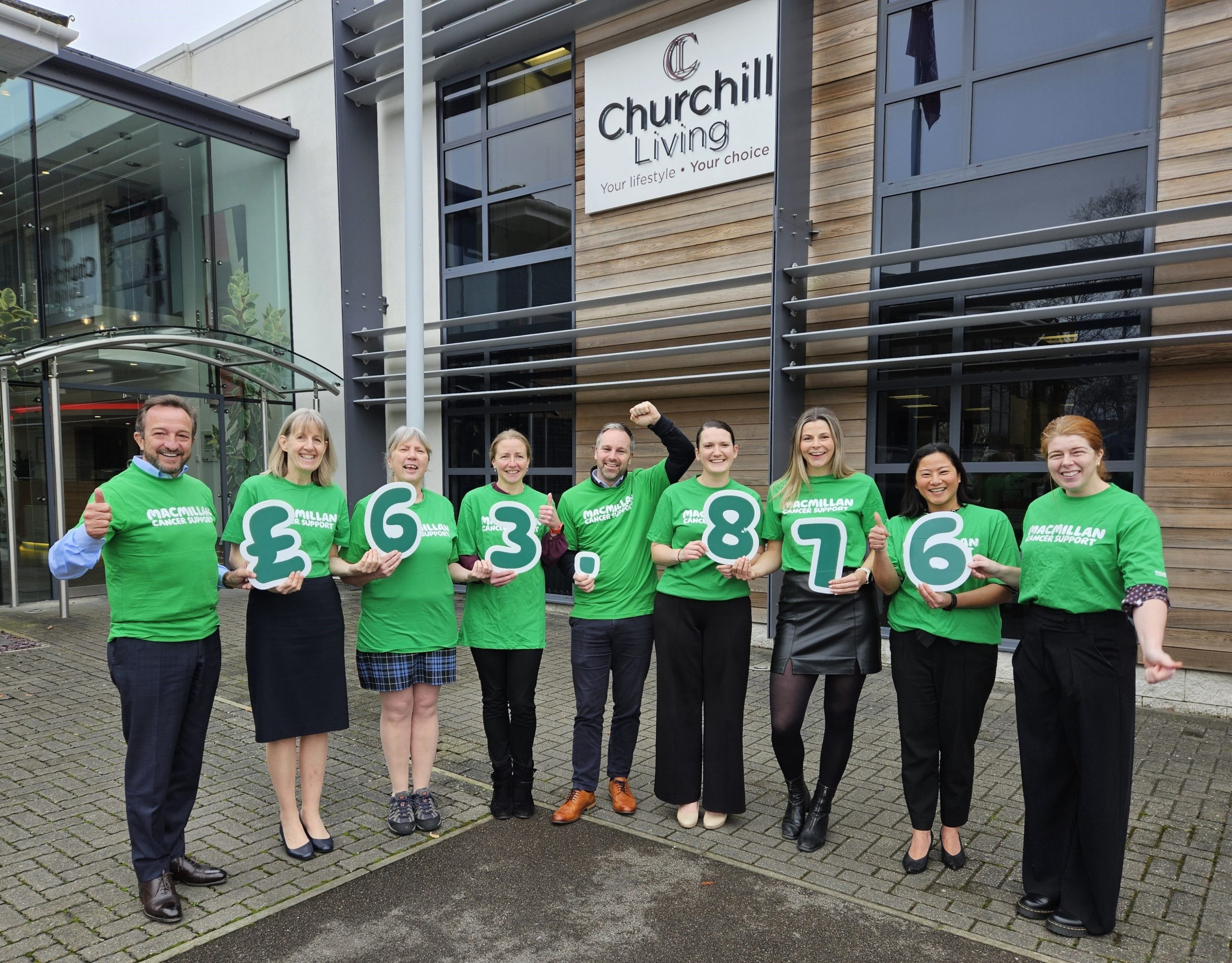Group of staff celebrating with charity numbers