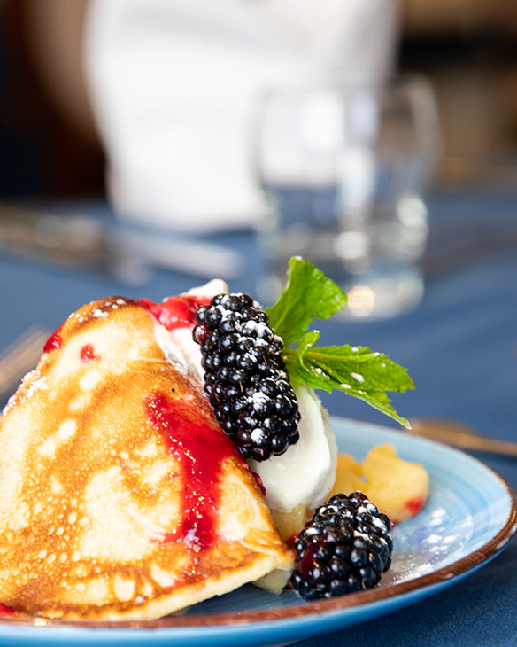 Delicious dessert with fresh blackberries and cream.